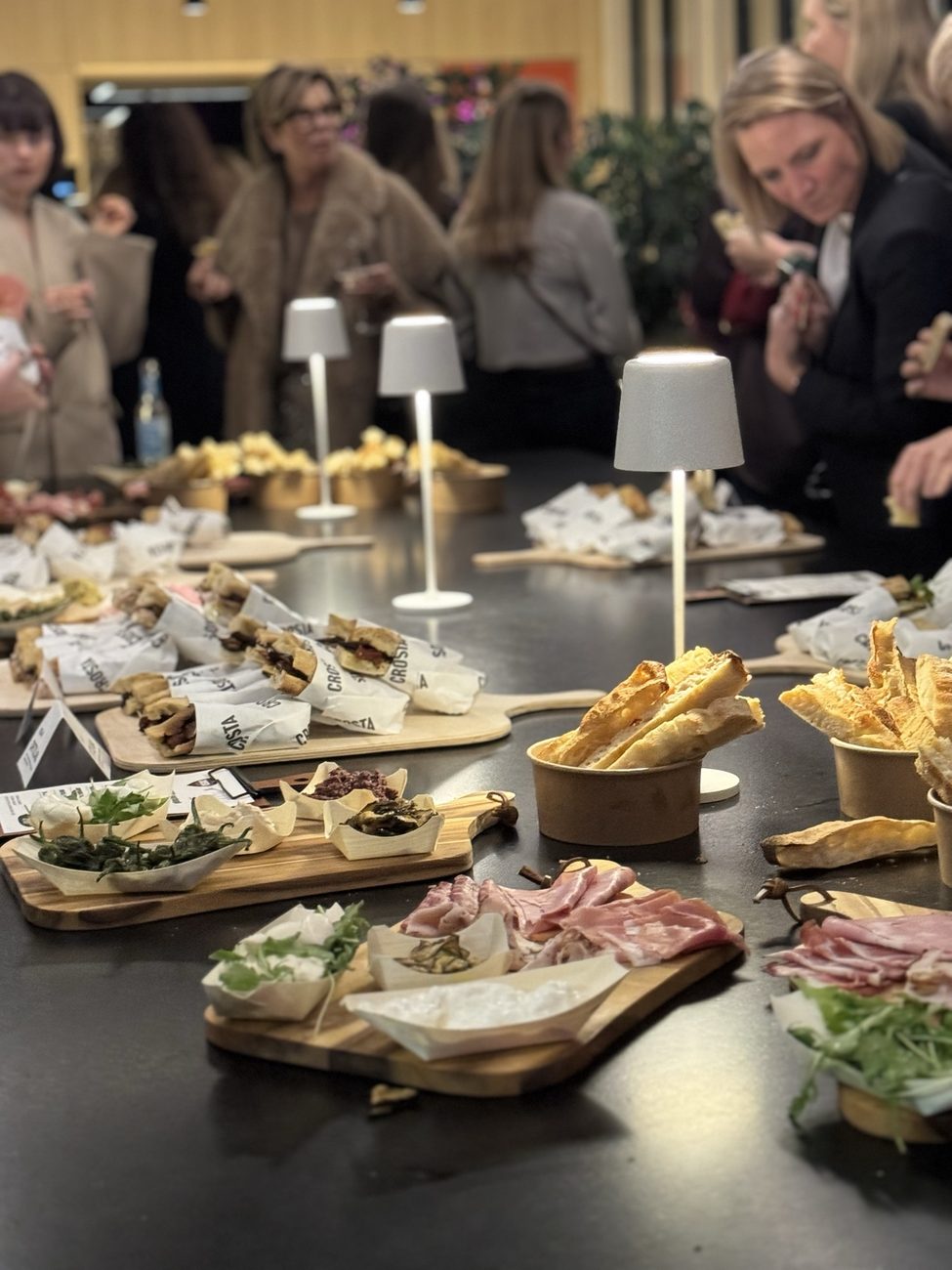 Guests helping themselves from the Crosta spread at an event