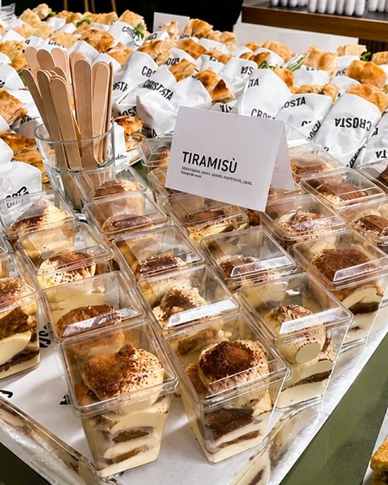 Tiramisù cups lined up on a tray at a Crosta catering in Berlin