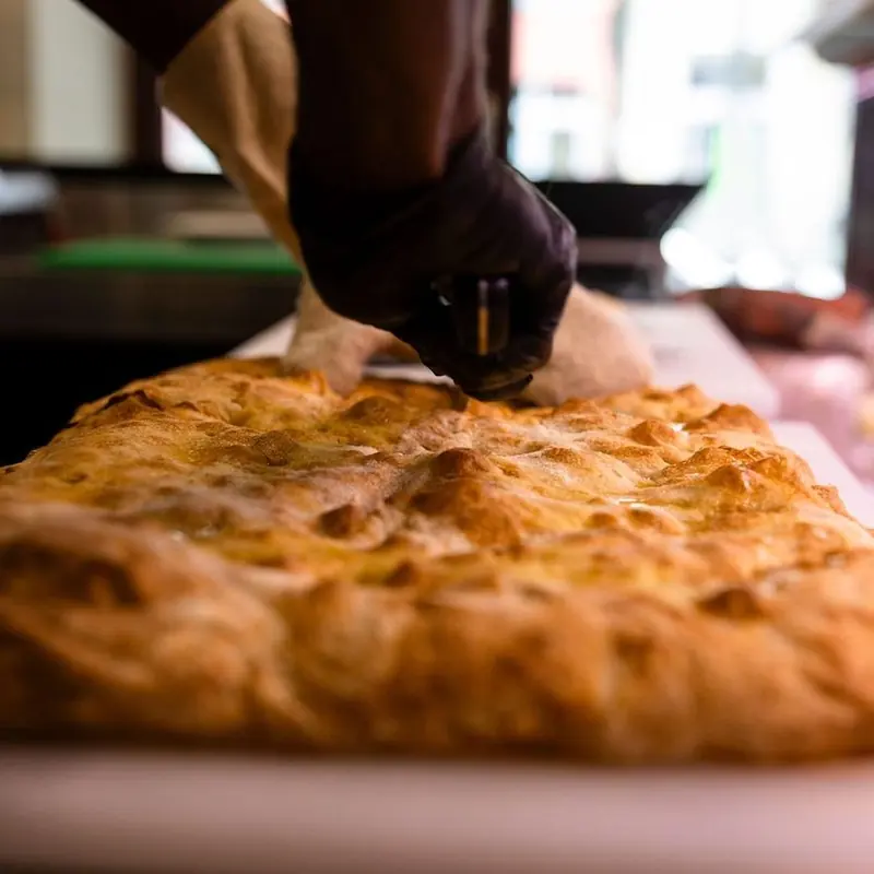 Golden blistered crust of a sourdough schiacciata fresh from the Crosta oven in Berlin